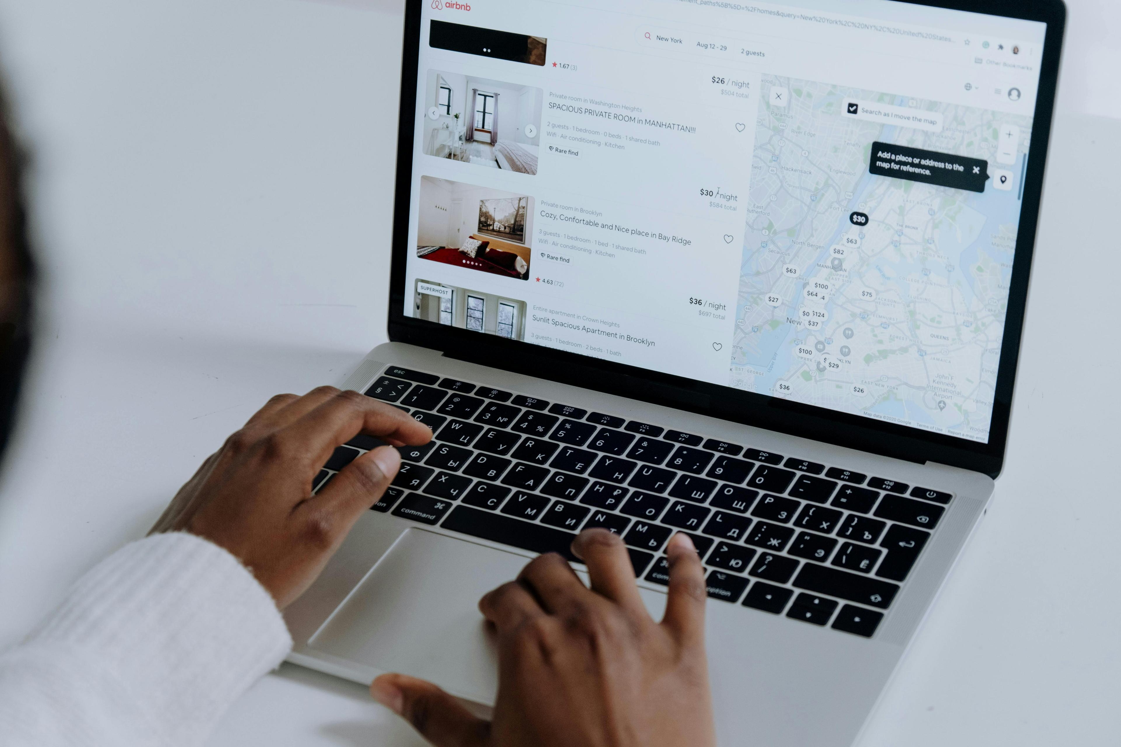 A woman has the Airbnb website open on her laptop