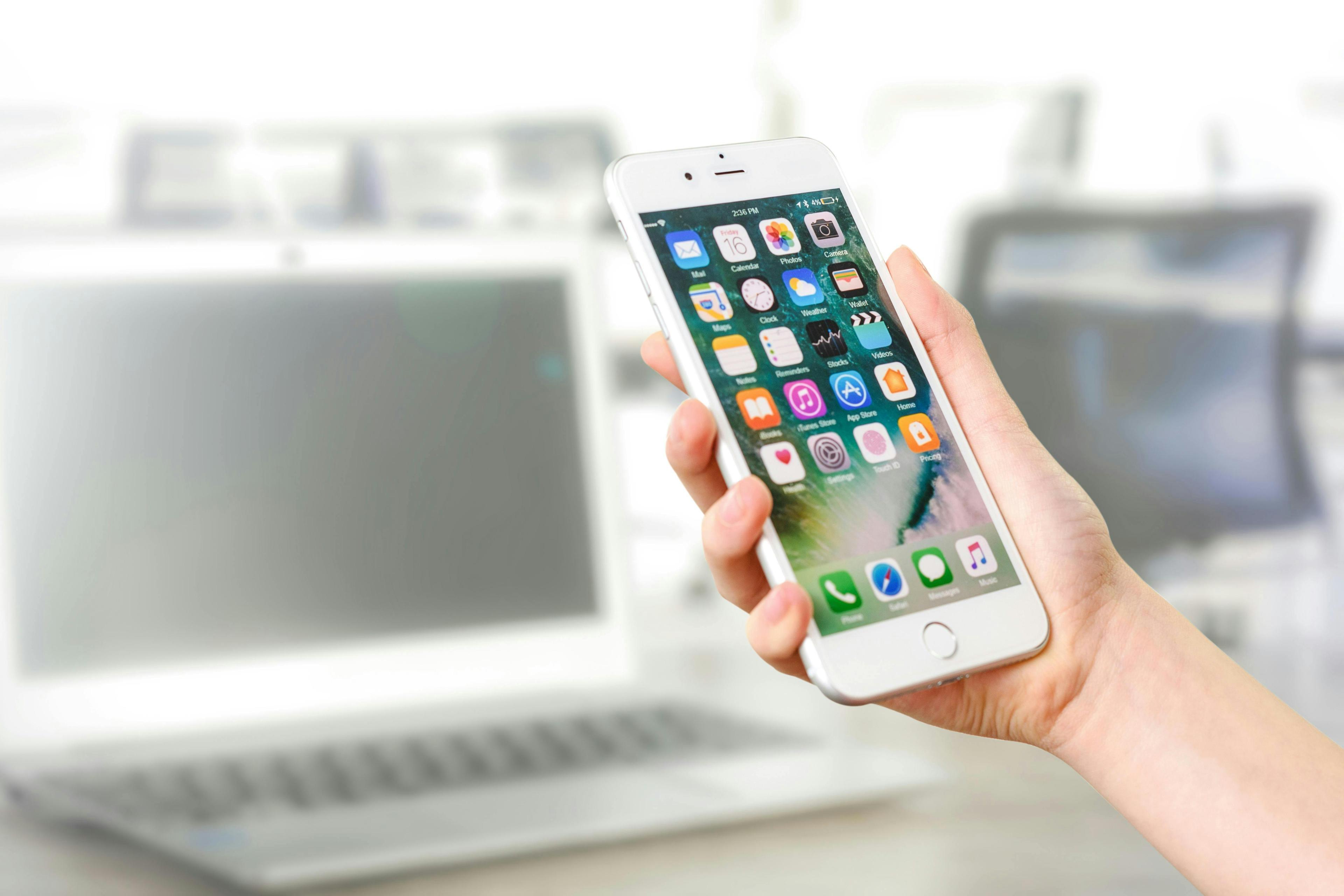 A woman holds an iPhone in her hand